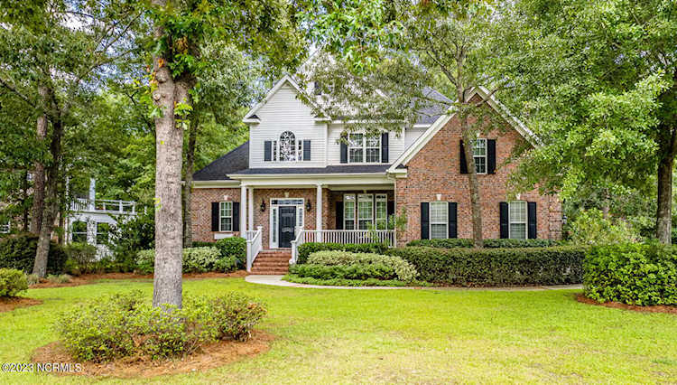 1556 Grandiflora Dr Leland, NC in Magnolia Greens. A Magnolia Greens home like no other. Shaded under tall pines on the 9th hole, 1556 Grandiflora... Photo 1