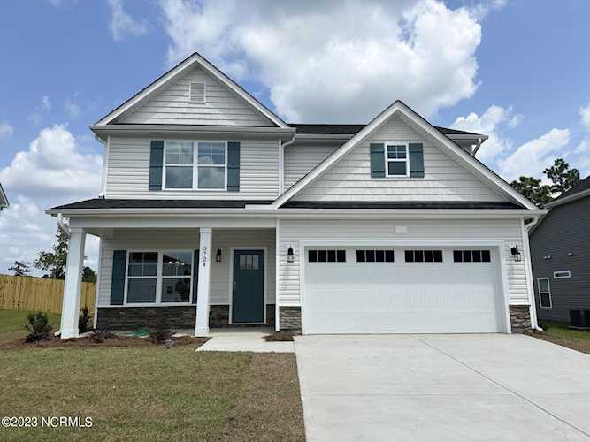 5724 Orchardgrass Rd Leland, NC in Grayson Park. The Bailey (A) plan by Windsor Homes builder is an inventory home with an inviting front porch... Photo 1